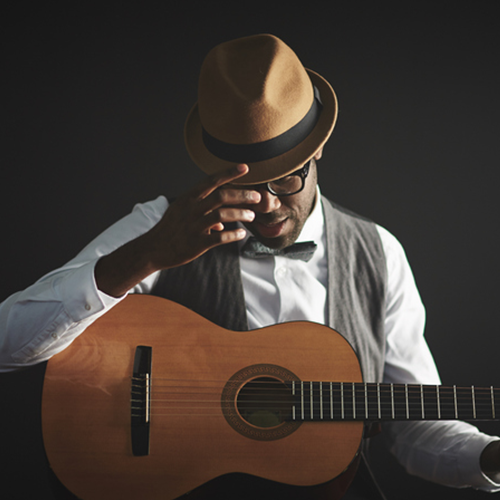 This is a stock photo of a man playing an acoustic guitar.  
